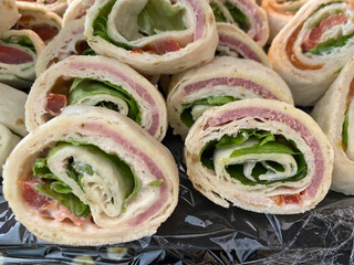 Close-up of mini wraps filled with various ingredients, neatly arranged for a fresh and appetizing look