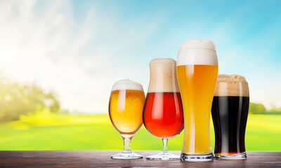An assortment of beer glasses filled with different types of beer