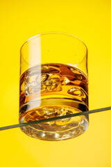 A classic whiskey glass filled with golden amber whiskey
