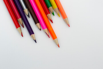 colored pencils on a white background