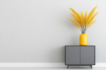 Yellow vase with golden pampas grass sits on gray cabinet