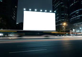 Fotobehang Blank billboard in night city with blurred bus and light trails, urban advertising concept. © Dina