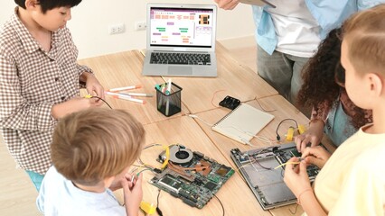 Top view of smart caucasian teacher coding engineering prompt and generated AI while diverse...