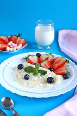 Healthy Breakfast with Oatmeal Berries and Milk on a Colorful Background