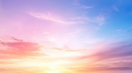 Obraz premium A serene sky with soft pastel colors blending from pink to blue, reflecting a peaceful and tranquil atmosphere during sunset or sunrise.