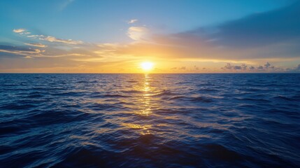 Naklejka premium A stunning sunset over the ocean, casting golden reflections on the water