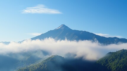 A majestic mountain peak rises above the clouds, surrounded by lush greenery under a clear blue sky, creating a serene and breathtaking landscape.