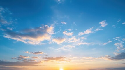 Fototapeta premium A serene sunset sky filled with soft clouds, showcasing beautiful hues of blue and orange, creating a tranquil atmosphere.