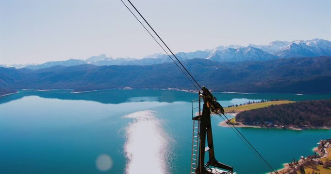 Ride on a cable car offering breathtaking views of the lake and mountains during a sunny day
