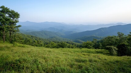 A serene view of rolling mountains and lush greenery under a clear sky, capturing the beauty of nature's landscape.