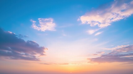 Obraz premium A serene sunset sky featuring soft clouds, transitioning colors, and a tranquil atmosphere, creating a calming visual experience.