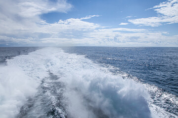 The ocean is calm and the sky is blue