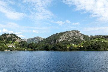 Fototapeta premium A calm lake with a mountain in the background in Norway fjord land