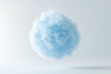 A light blue, fluffy cloud-like mass floats against a white background, evoking softness and tranquility.