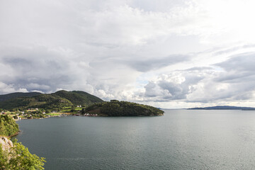 A cloudy day in Norway with a lake in the background