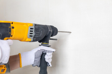 Perforating machine is drilling the wall.