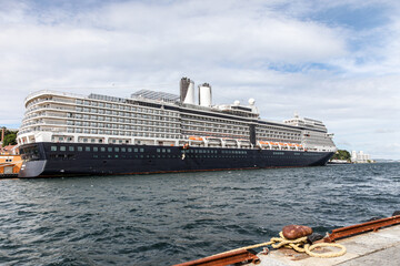 A large cruise ship is docked at a pier in Stavanger Norway