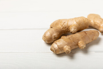 Fresh ginger on wooden background. Dry ginger. Sliced ​​ginger with honey and lemon. Ginger root. Traditional alternative medicine, healing tea for immunity. Seasoning and spices concept. Copy space.