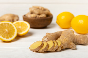 Fresh ginger on wooden background. Dry ginger. Sliced ​​ginger with honey and lemon. Ginger root. Traditional alternative medicine, healing tea for immunity. Seasoning and spices concept. Copy space.