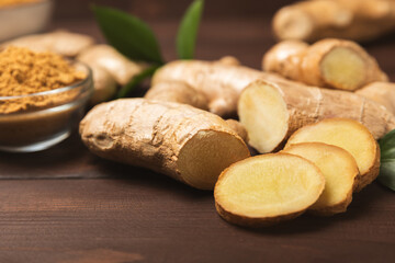 Fresh ginger on wooden background. Dry ginger. Sliced ​​ginger with honey and lemon. Ginger root. Traditional alternative medicine, healing tea for immunity. Seasoning and spices concept. Copy space.