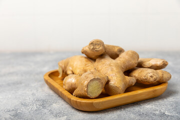 Fresh ginger on wooden background. Dry ginger. Sliced ​​ginger with honey and lemon. Ginger...