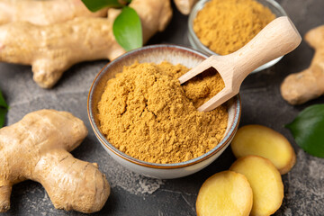 Fresh ginger on wooden background. Dry ginger. Sliced ​​ginger with honey and lemon. Ginger root. Traditional alternative medicine, healing tea for immunity. Seasoning and spices concept. Copy space.