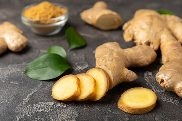 Fresh ginger on wooden background. Dry ginger. Sliced ​​ginger with honey and lemon. Ginger root. Traditional alternative medicine, healing tea for immunity. Seasoning and spices concept. Copy space.