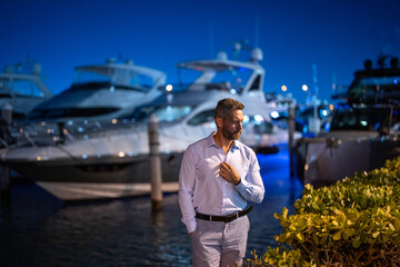 Rich millionaire man near yacht. Wealthy charismatic millionaire business man with luxury...