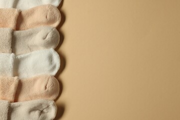 Baby socks on beige background, flat lay