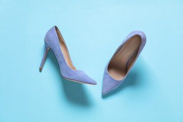 Pair of high heeled shoes on light blue background, flat lay