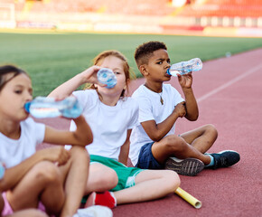 child sport athlete exercise running water bottle drink drinking refreshment thirsty resting plastic break active young childhood fitness jogging training athletic