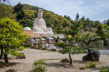Fototapeta premium Ryozen Kannon is a war memorial dedicated to WWII soldiers in Kyoto, Japan. The massive statue of Kannon, the Buddhist deity of mercy, sits atop a temple on hillside.