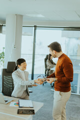 Successful business meeting between two professionals in a modern office setting