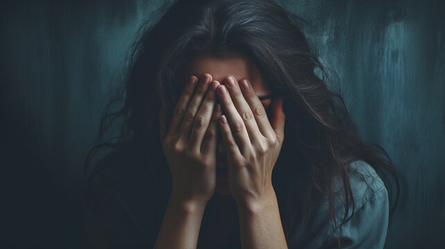 depressed woman covering her face with hand