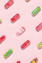 Medical pill capsules filled with colorful sugar sprinkles, creative concept