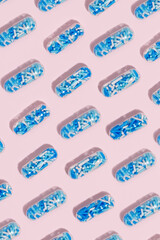 Medical pill capsules filled with colorful sugar sprinkles, creative concept