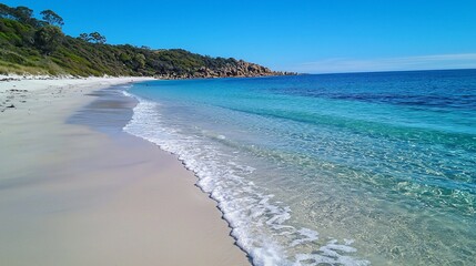 Fototapeta premium Idyllic coastal scene featuring tranquil waters and pristine sands on a sunny day