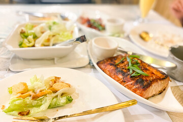 tuna steak and caesar salad on a table in a restaurant