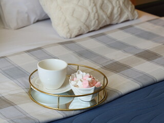 A Cozy Bed Scene Decorated with Tea and Sweets, All Beautifully Arranged on a Tray