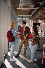 Happy college student and his female friends communicating after a lecture.