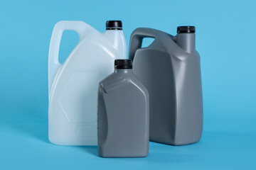 Different plastic canisters on light blue background