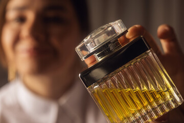 Young beautiful woman with perfume
