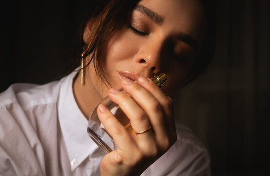 Young beautiful woman with perfume