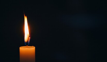 Candle with warm flame against dark background, Close-up, dramatic,