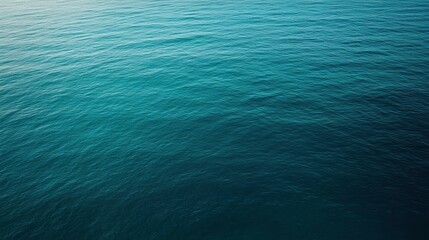 Serene ocean surface with gentle waves reflecting sunlight, creating a tranquil coastal atmosphere