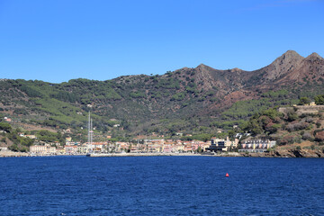 Porto Azzurro seen from the sea against high mountain. Elba Island.  Tuscany., Italy. 