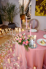 Romantic dinner, decorated table with candles and flowers in pink style. candles romance