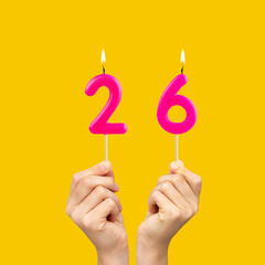 Birthday number 26 - Hands holding fuchsia colored candles