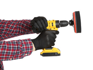 Man holding electric screwdriver with polish pad on white background, closeup