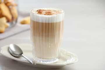 Tasty latte macchiato in glass on white table, space for text. Coffee drink